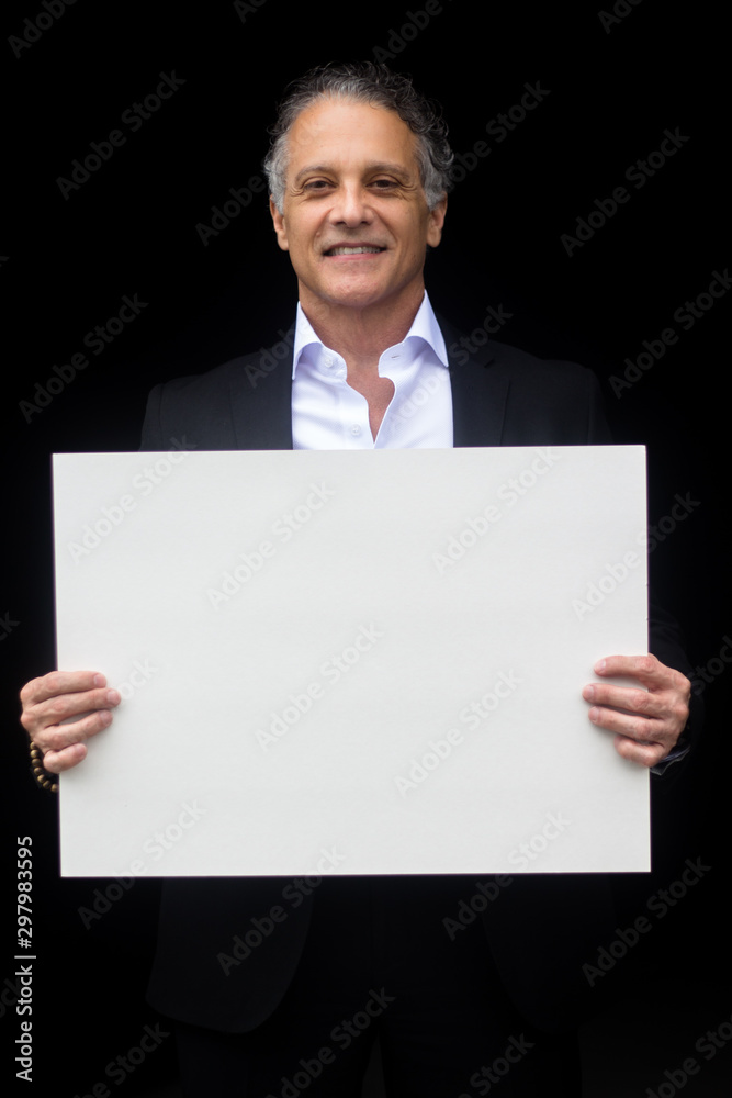 Successful Businessman in suit smile in front of camera and holding nameplate Successful Businessman in suit smile in front of camera and holding nameplate