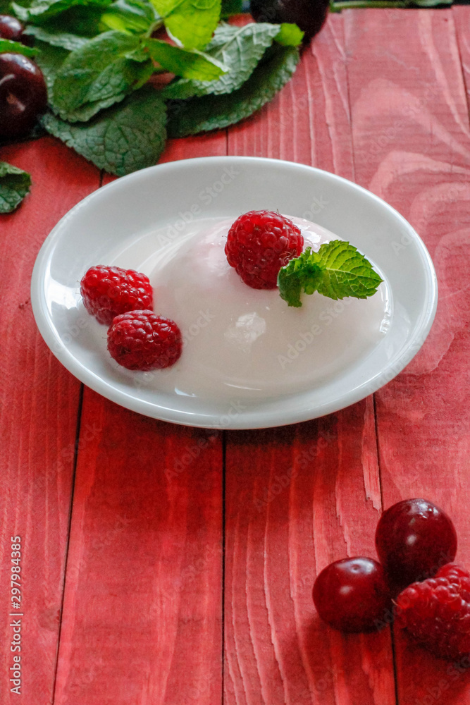 Panacota decorated with raspberries and mint