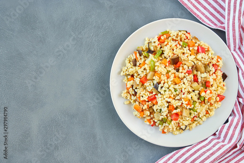 Bulgur pilaf with eggplant and vegetables. Top view with copy space 