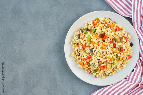Bulgur pilaf with eggplant and vegetables. Top view  with copy space              