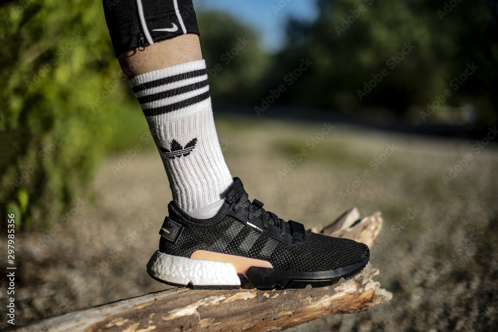 oung man wearing Adidas POD-S3.1 shoes outside foto de Stock | Adobe Stock
