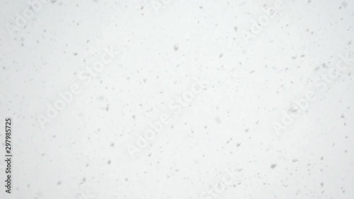 Snowfall slow motion. Snowflakes beautifully whirl and slowly fall down.