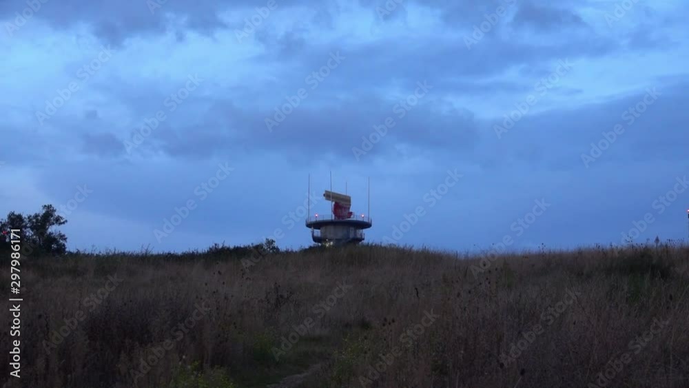 A radio surveillance tower spins a radar. Surveillance aviation radar system, border, command and control system.
