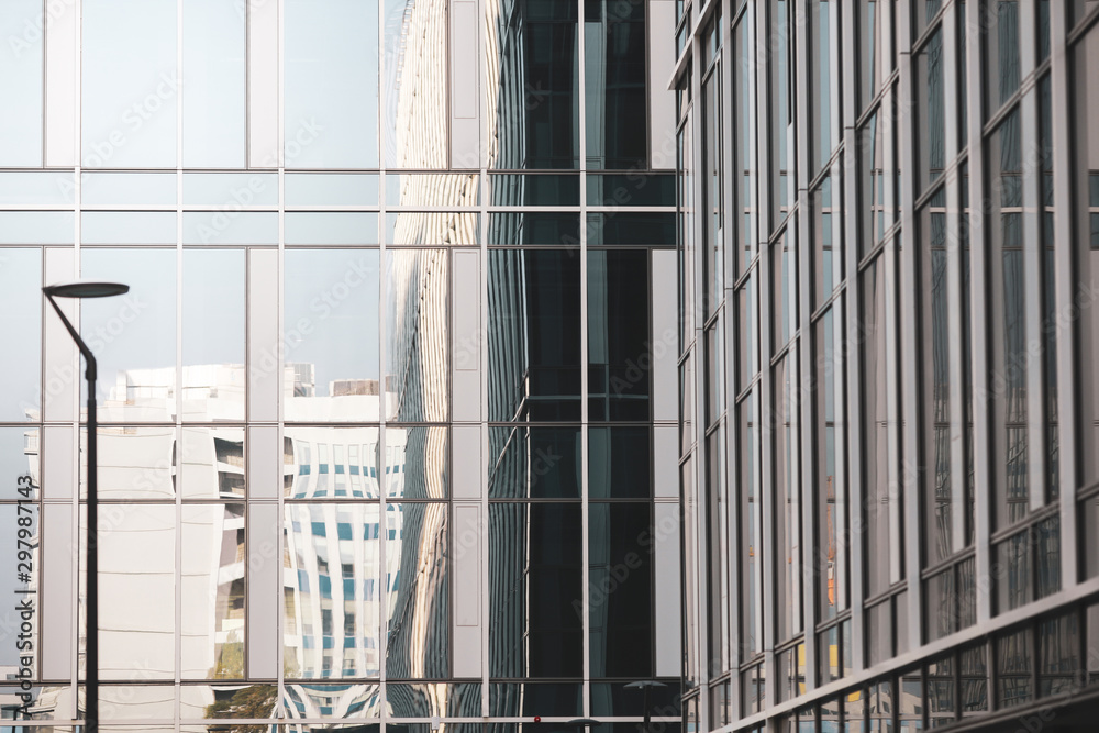Details with the windows and glass walls and reflections in them of an office/business modern building. Details with the windows and glass walls and reflections in them of an office/business modern building.