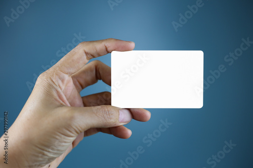 Hand holding a blank piece of paper. Close up white business card.