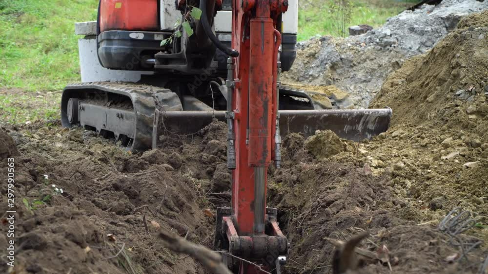 excavator digs a hole, construction work, preparation for the foundation
