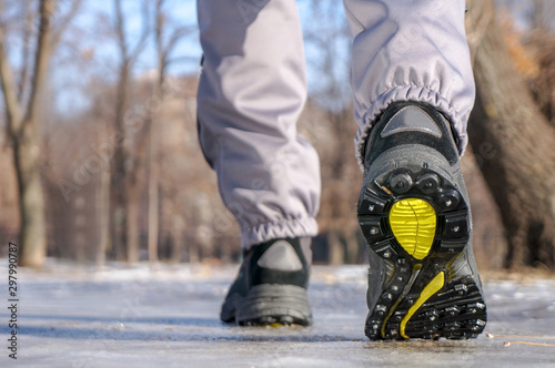 male or female winter boots walking on snowy sleet road photo