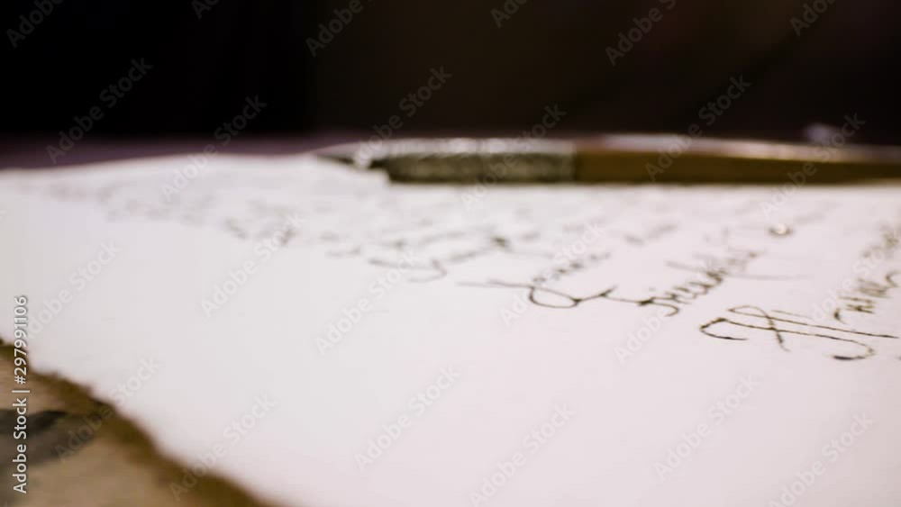 Calligraphy in slow motion. Pan shot of hand written page. Vintage ink pen and quill pen Calligraphy in slow motion. Pan shot of hand written page. Vintage ink pen and quill pen