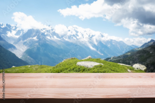 Empty wooden table on the background of scenic mountain Alpine landscape.