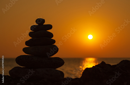 Zen concept. Sunset. The object of the stones on the beach at sunset. Relax & Meditation.