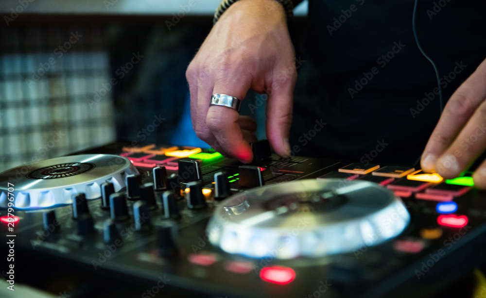 DJ Hands creating and regulating music on dj console mixer in concert nightclub stage. DJ Hands creating and regulating music on dj console mixer in concert nightclub stage.