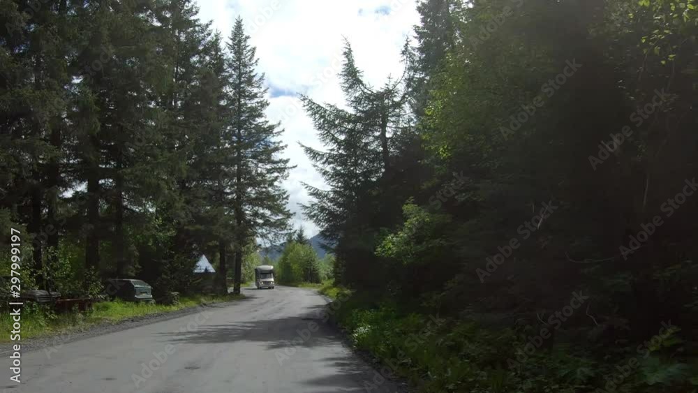 Looking out the back of the car while driving by trees and Spruce Creek at Resurrection Bay on Lowell Point; near Seward Alaska Looking out the back of the car while driving by trees and Spruce Creek at Resurrection Bay on Lowell Point; near Seward Alaska