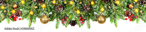 Amazing christmas border with fresh fir branches isolated on white. Golden balls, snow, cones, little light and red berries composition.