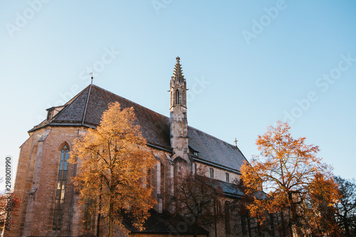 Beautiful view of the church of St. Jacob in Rottenbourg ob der Tauber in Germany in the fall. Religious place and city attraction. photo