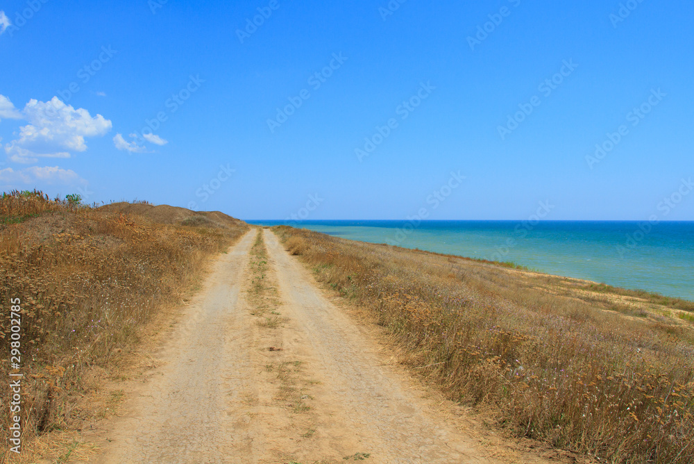 Beautiful dirt road by the sea