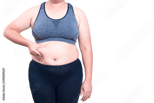 Asian fat women has overweight. she shows excess fat of the waist. isolated on white background. she wants lose weight. concept of surgery and subcutaneous fat breakdown.