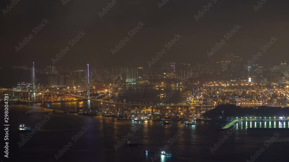Timelapse illuminated Hong Kong cityscape with modern overpass highways reflected in harbor water with sailing boats at night zoom out Timelapse illuminated Hong Kong cityscape with modern overpass highways reflected in harbor water with sailing boats at night zoom out