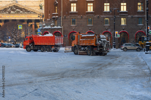 Snow removal equipment clears the city from the fallen snow on a winter morning (Saint Petersburg, Russia)