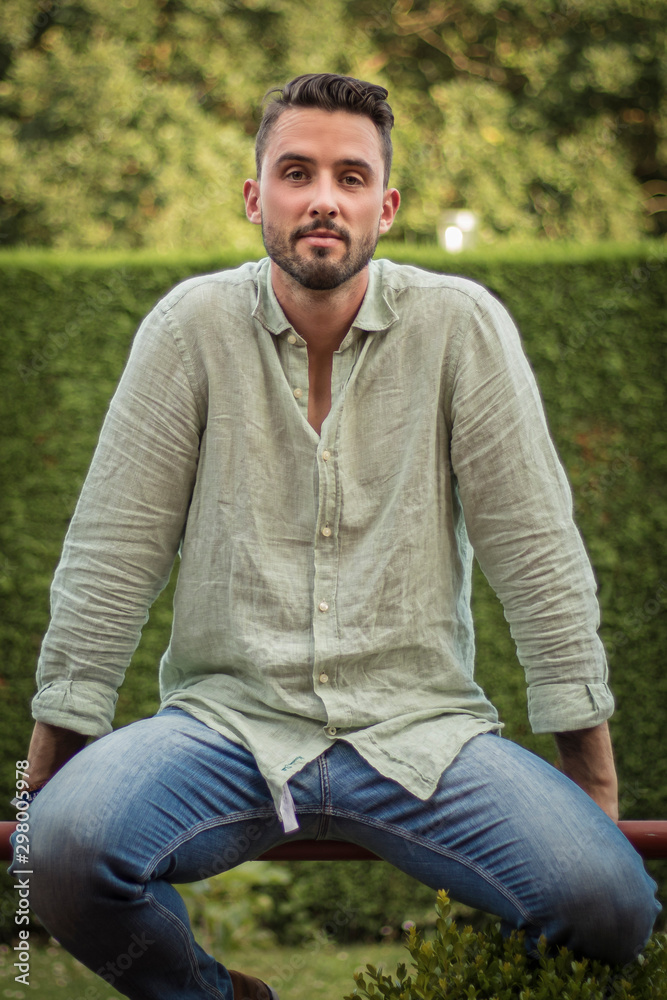 Portrait of a young man. Bearded man posing. Man wearing a green linen shirt. Surrounded by nature Portrait of a young man. Bearded man posing. Man wearing a green linen shirt. Surrounded by nature