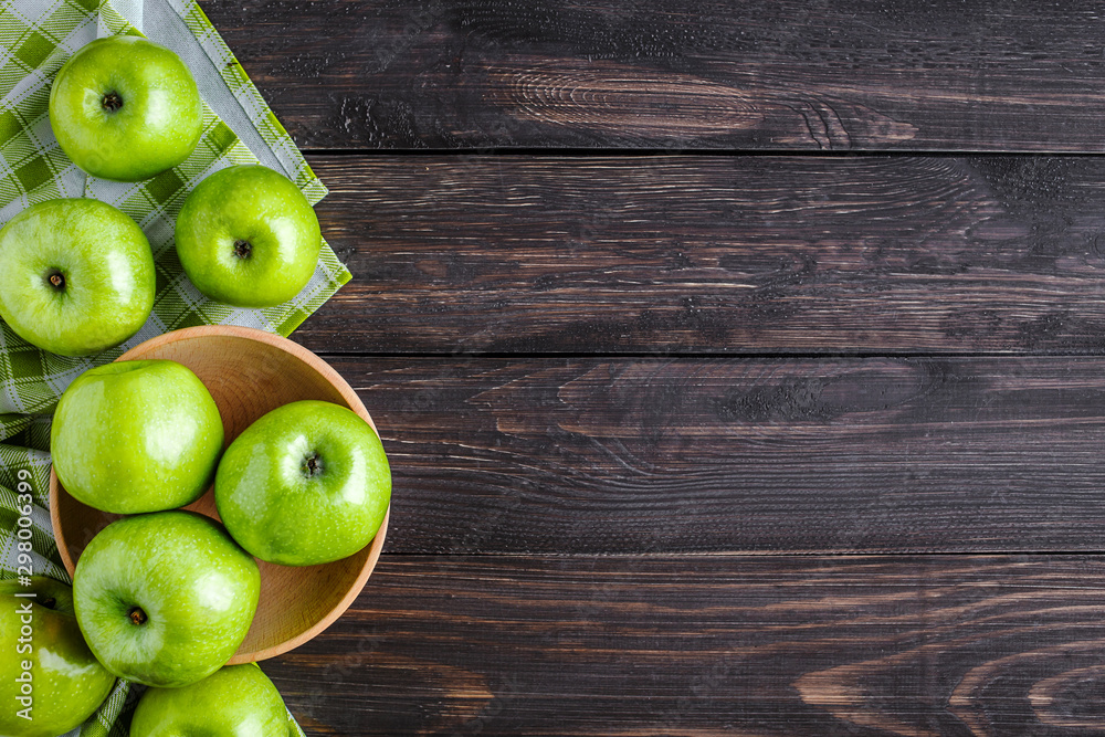 Ripe green apples and apple slices on old wooden background.Vegetables for diet and healthy eating.Organic food. Place for text. Top view Ripe green apples and apple slices on old wooden background.Vegetables for diet and healthy eating.Organic food. Place for text. Top view