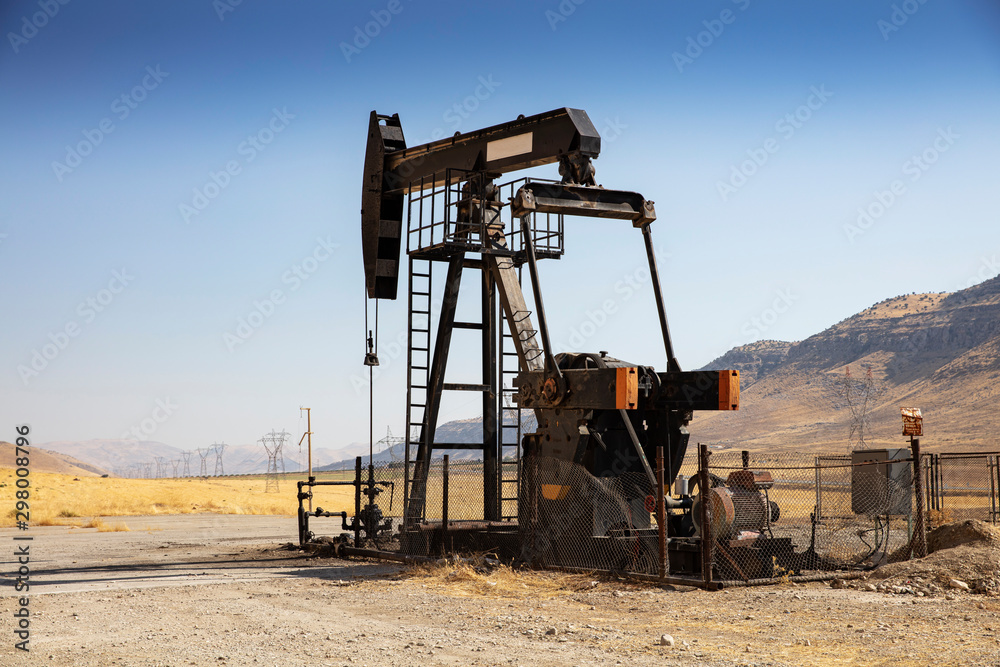 Oil drilling derricks at desert oilfield. Crude oil production from the ground. Oilfield services contractor. Oil drill rig and pump jack. Petroleum production, natural gas, liquids, NGL, additive. Oil drilling derricks at desert oilfield. Crude oil production from the ground. Oilfield services contractor. Oil drill rig and pump jack. Petroleum production, natural gas, liquids, NGL, additive.