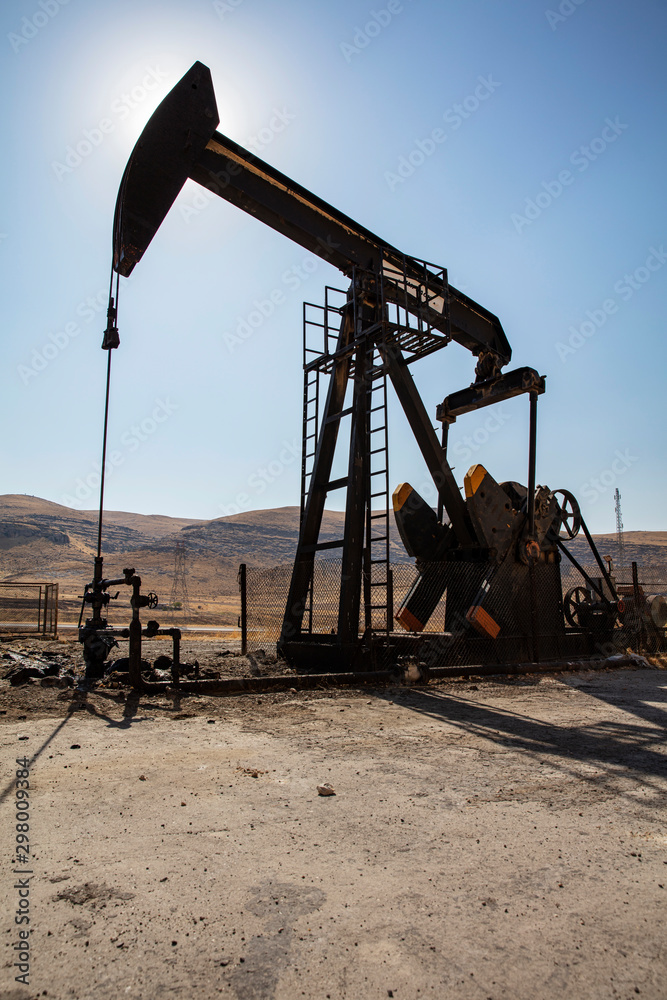 Oil drilling derricks at desert oilfield. Crude oil production from the ground. Oilfield services contractor. Oil drill rig and pump jack. Petroleum production, natural gas, liquids, NGL, additive. Oil drilling derricks at desert oilfield. Crude oil production from the ground. Oilfield services contractor. Oil drill rig and pump jack. Petroleum production, natural gas, liquids, NGL, additive.