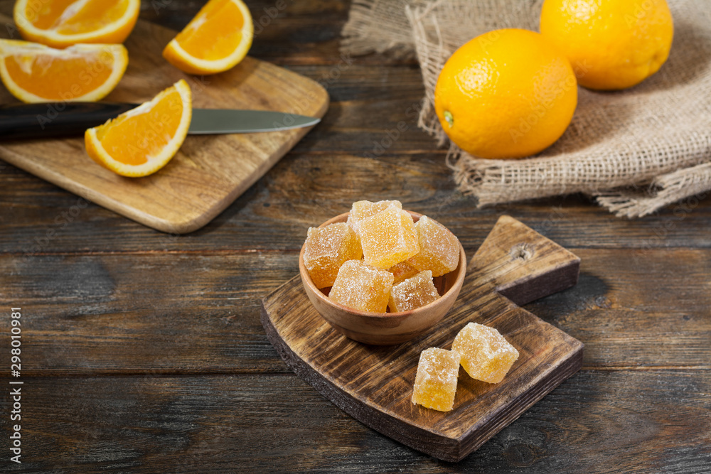 Marmalade sprinkle with sugar in a wooden bowl on a wooden table Marmalade sprinkle with sugar in a wooden bowl on a wooden table