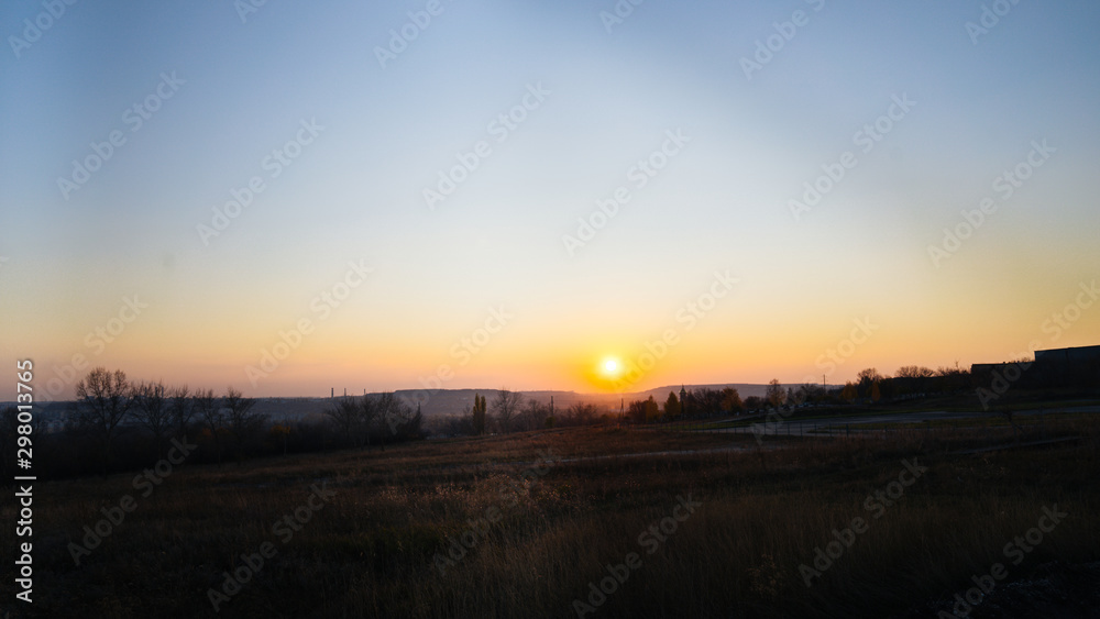 Sunset in the countryside, evening in the village. Sunset in a hilly area