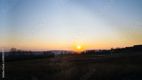 Sunset in the countryside, evening in the village. Sunset in a hilly area