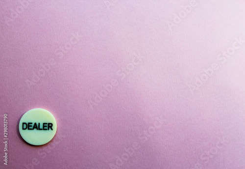 Chip dealer lies in the cner on a pink background. T he game of poker. Place for text. Gambling.