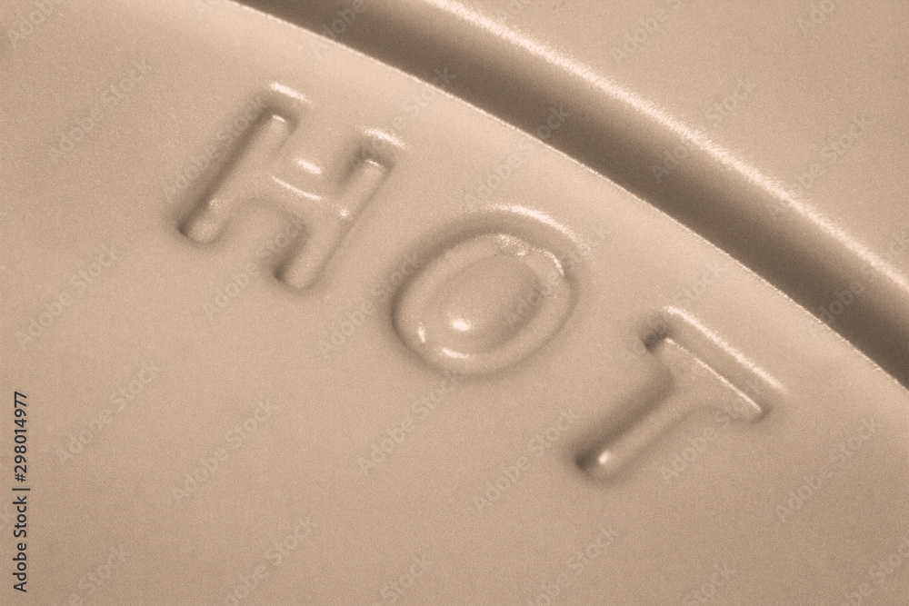 Hot warning sign at the lid of a coffee cup Hot warning sign at the lid of a coffee cup