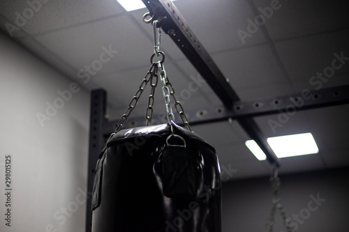 Sports Equipment. Punching bag. Gym. The simulator for muscle training. Black punching bag. © Олег Копьёв