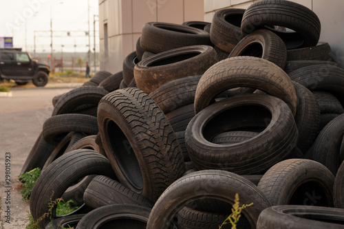 large pile of tires dump. Illegal garbage dump. The concept of ecology pollution. grown man in his underwear: red boxers.: red boxers. man putting hand in underwear.