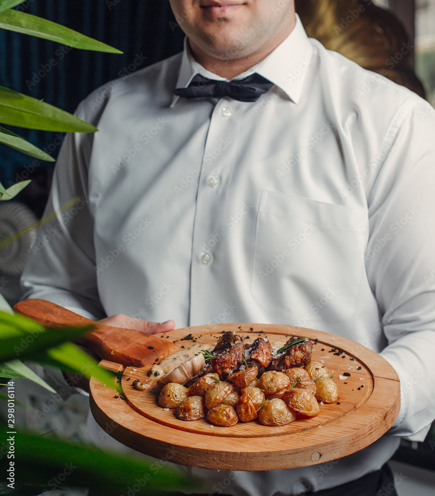 fried meat and potato on wooden board