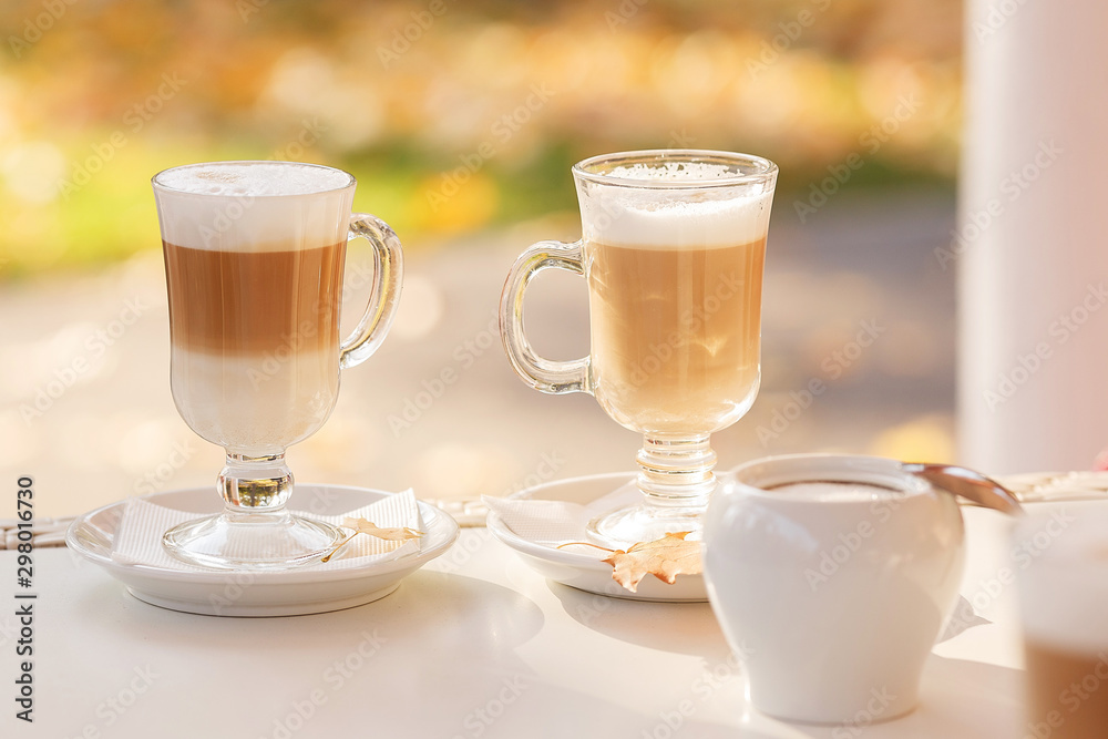 breakfast in a street cafe. two glasses with a latte on a sunny autumn day. Couple's Date. Selective focus breakfast in a street cafe. two glasses with a latte on a sunny autumn day. Couple's Date. Selective focus