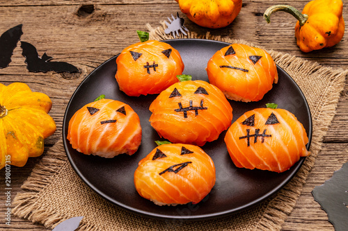 Funny Halloween Sushi Pumpkins Jack o Lantern, Sushi Monsters. Temari sushi, sushi balls. Healthy food for kids photo