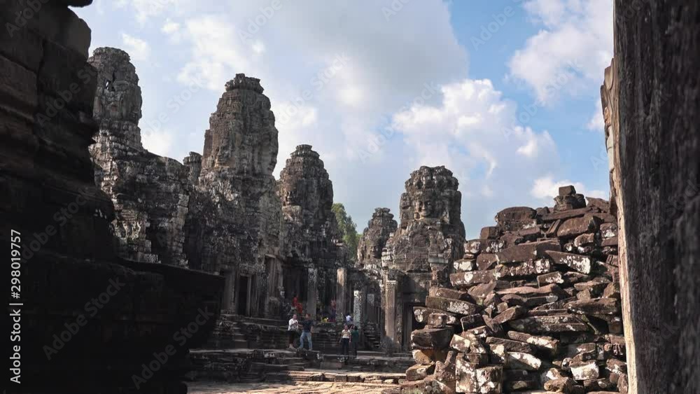 Temple at Angkor Wat Complex with Blue Skies, Clouds and Piles of Rocks Temple at Angkor Wat Complex with Blue Skies, Clouds and Piles of Rocks