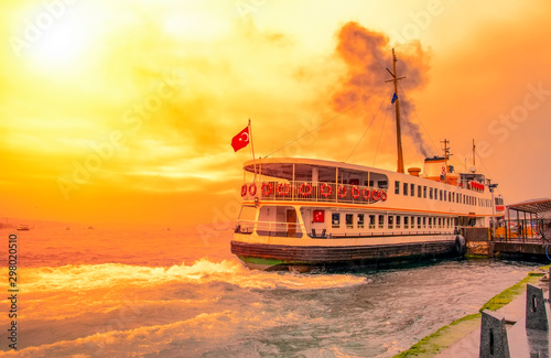  Muslim architecture and water transport in Turkey - Beautiful View touristic landmarks from sea voyage on Bosphorus. Cityscape of Istanbul at sunset - old mosque and turkish steamboats, view on Golde photo
