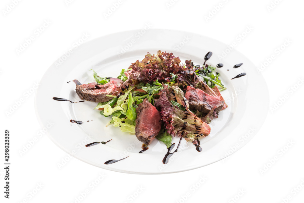 Spicy roast beef Salad with green mix and balsamic sauce isolated on white background
