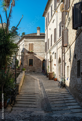 Fototapeta Naklejka Na Ścianę i Meble -  Old buildings on small italian street. Narrow street in Italy.