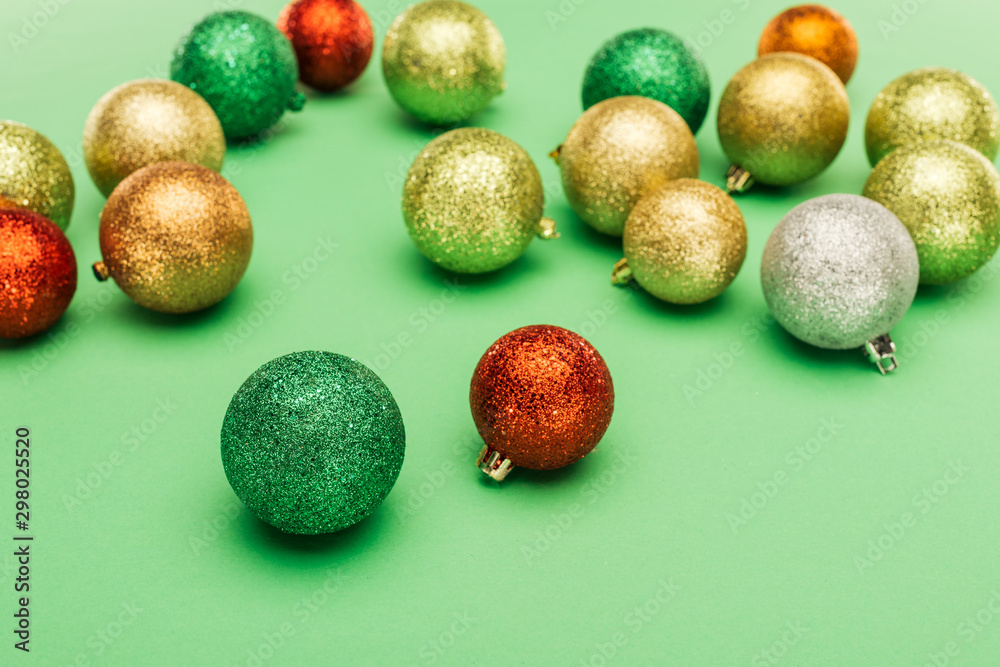 selective focus of multicolored Christmas baubles on green background selective focus of multicolored Christmas baubles on green background