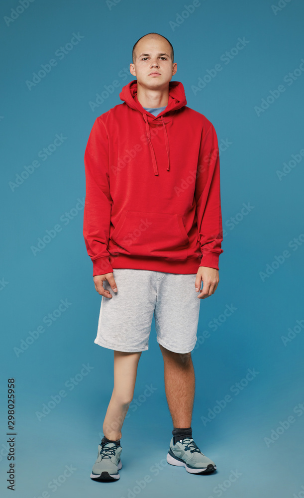 Φωτογραφία Portrait of young disabled teenager in hoodie and in shorts looking at camera ag
