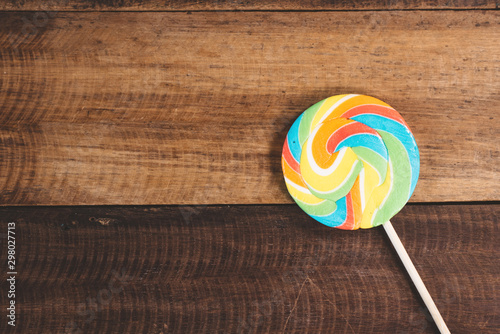 Swirl round lollipop on wooden table background. concept of unhealthy food,sweets and candy day