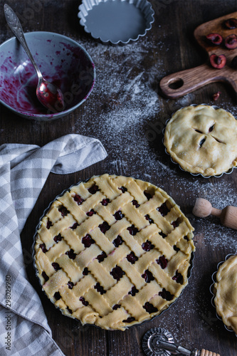 Bakery produce, cherry pie with ingredients on rustic wooden background