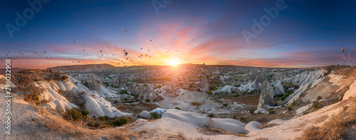 Beautiful scenes in Goreme national park. Hundreds of colorful hot air balloons flying in the sky on sunrise. Incredible rock formations in the valley Cappadocia, Turkey