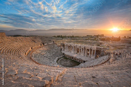 Beautiful sunset view of the Ancient theater of the Roman city of Hierapolis in Pamukkale, Turkey. The site is a UNESCO World Heritage site near the city of Denizli.  photo