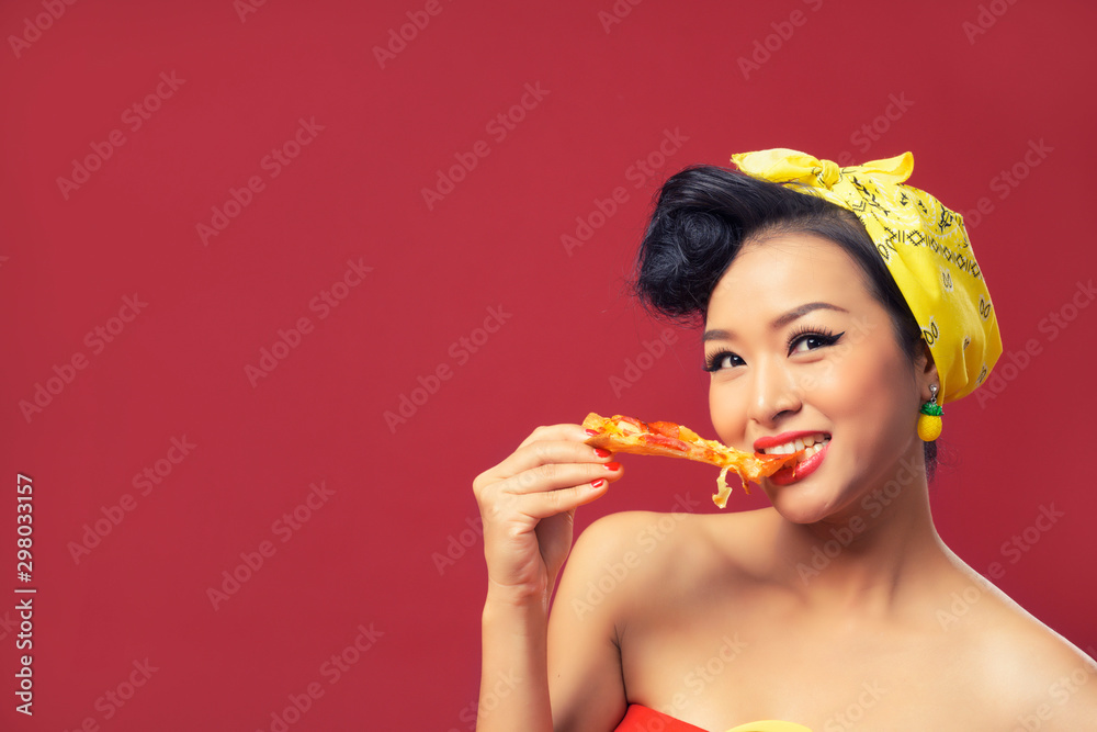 Beautiful Asian young woman eating pizza on red background, Isolated. Beautiful Asian young woman eating pizza on red background, Isolated.