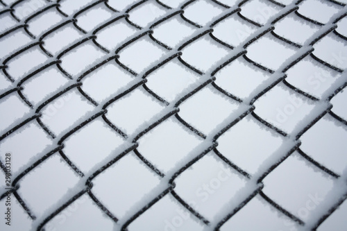metal fence frozen in winter