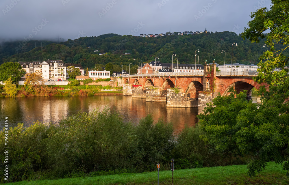 Scenic view of ancient Roman bridge illuminated by sun, Trier, Rhineland-Palatinate, Germany