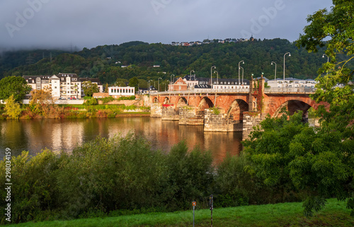 Scenic view of ancient Roman bridge illuminated by sun, Trier, Rhineland-Palatinate, Germany photo